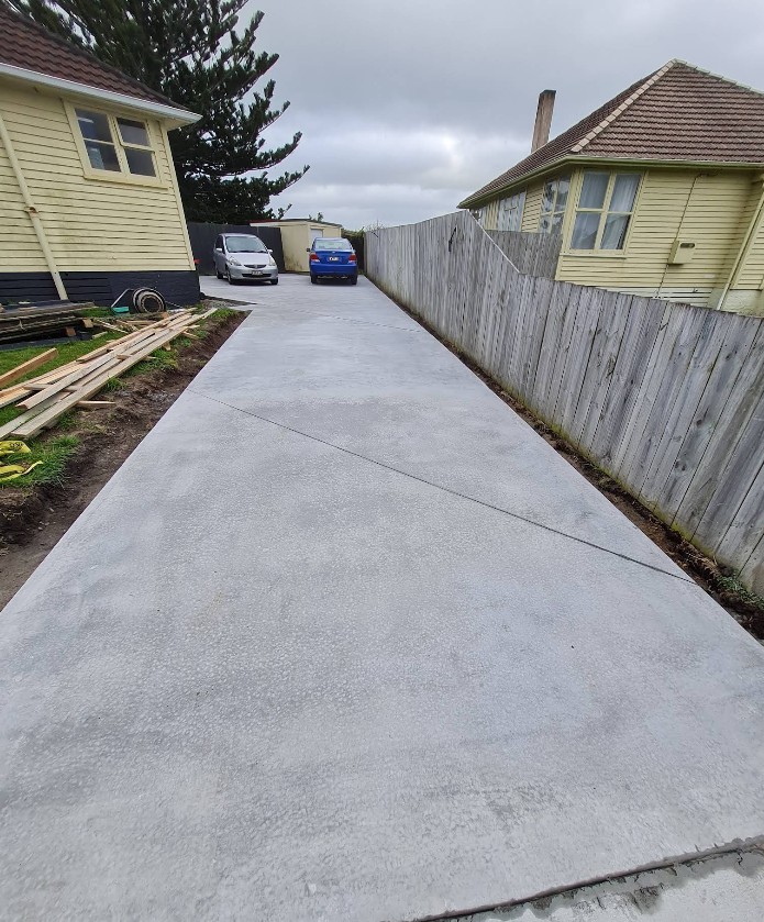 New concrete driveway running the full length of a Hamilton property
