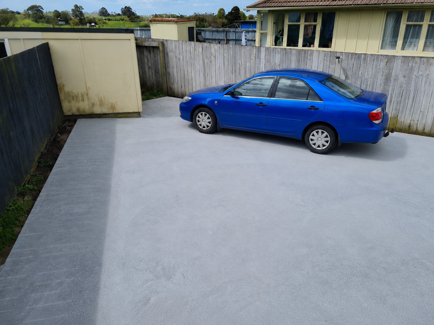 Finished residential concrete driveway and parking area at a Hamilton home